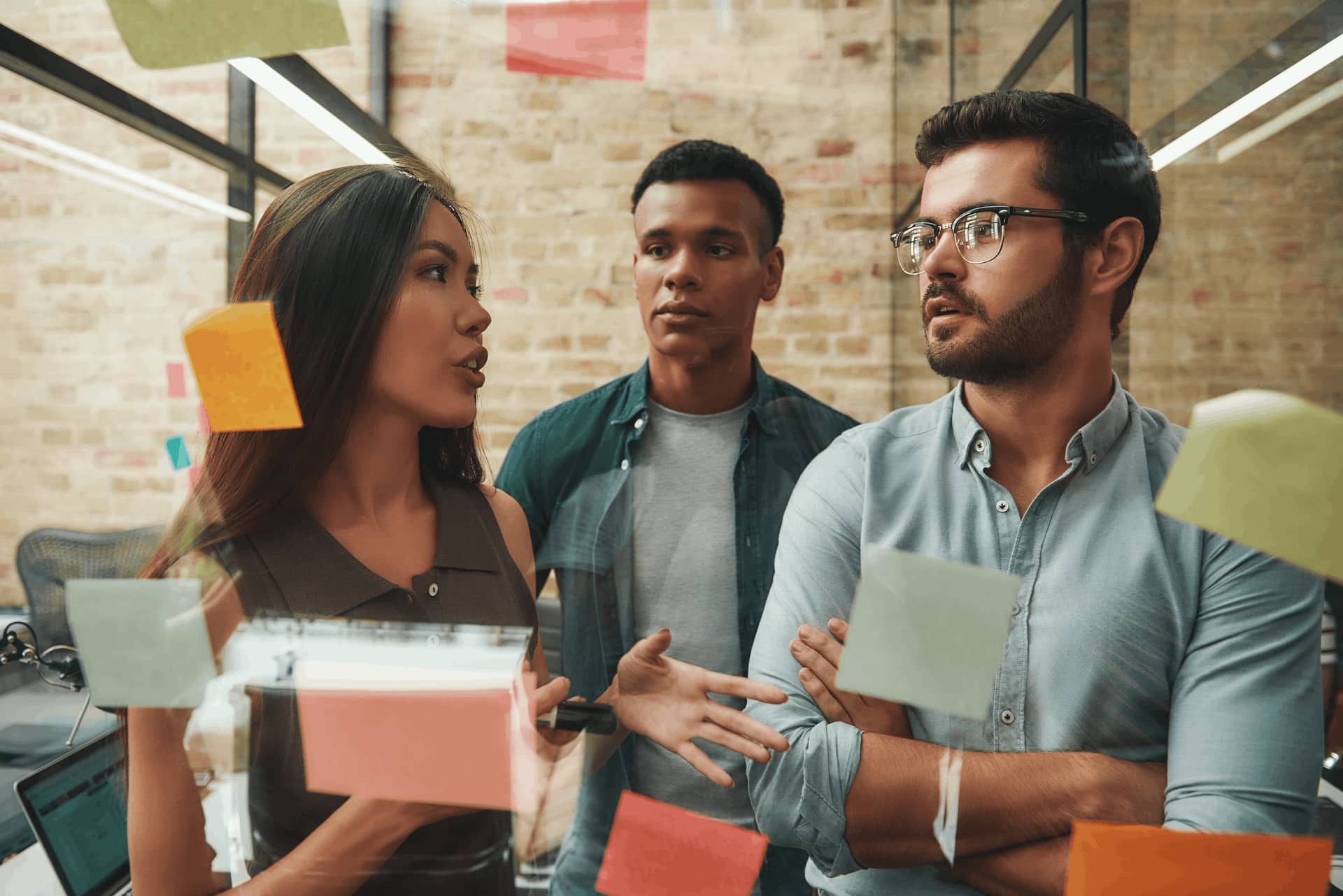 3 colegas de trabalho conversando sobre o que pode diminuir a produtividade no trabalho. 